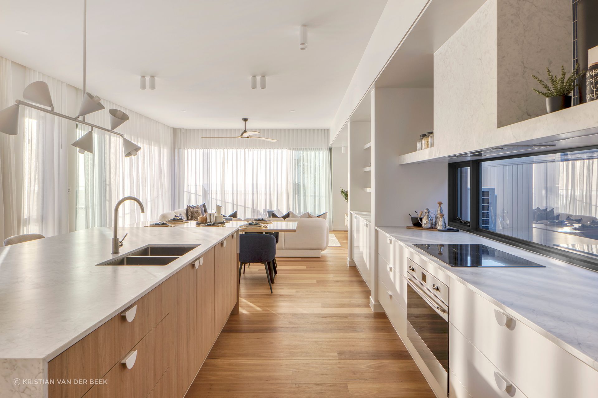 A neutral colour palette links the downstairs living spaces | Currumbin Beach House by Habitat Studio Architects