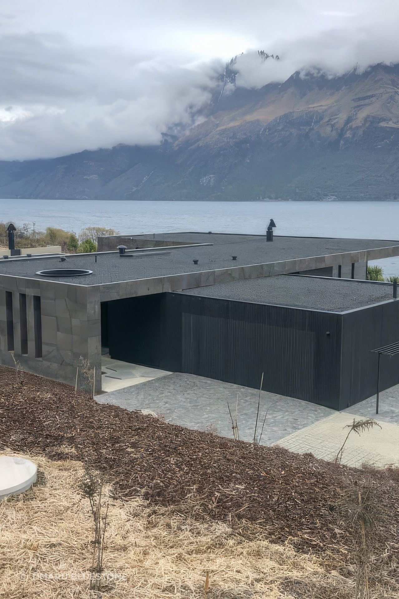 The bluestone cladding on this home pairs perfectly with the rugged mountain range.