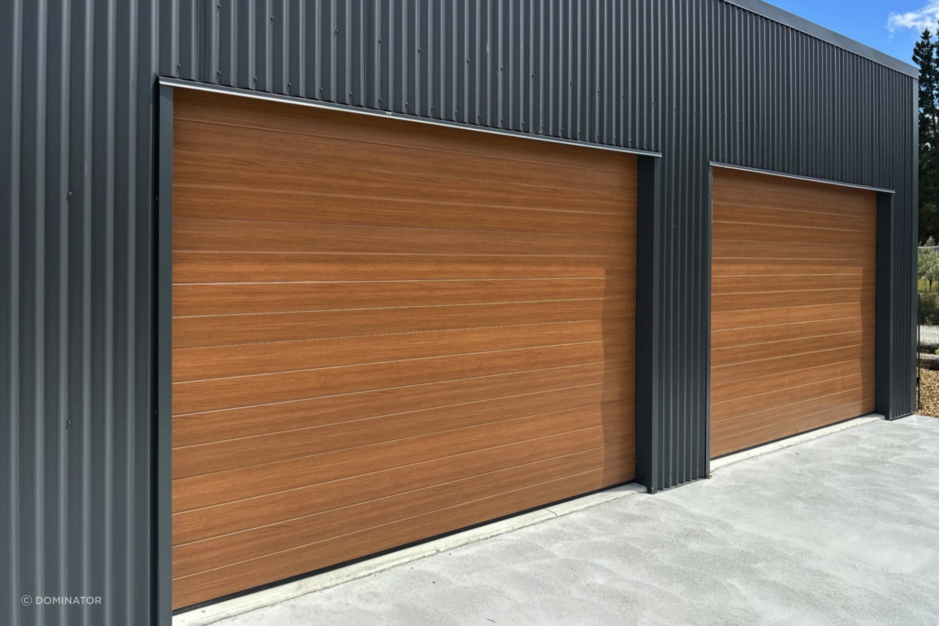 Dominator NatureSteel garage doors  are the perfect combination of beauty and strength. NatureSteel material mimics the look of natural timber, giving your garage a sophisticated finish that will elevate the overall aesthetic of your property.