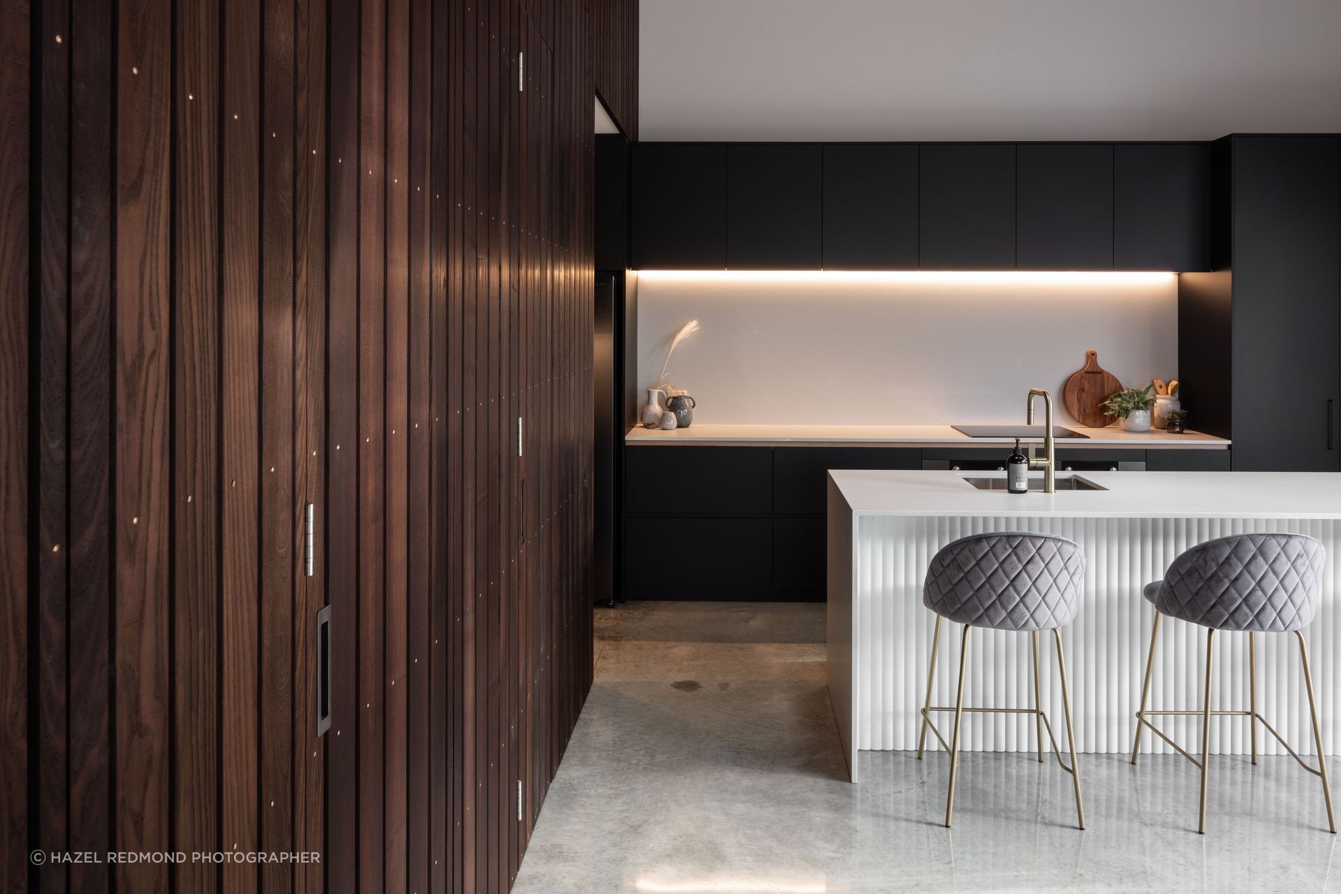 The vertical shiplap Thermory Ash provides a dramatic contrast against the polished concrete floor in this Hawke's Bay new build.