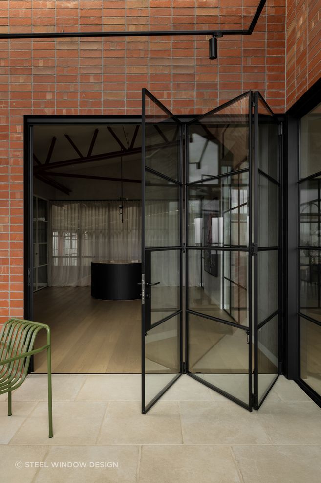 Steel bifold doors glide with engineered ease.