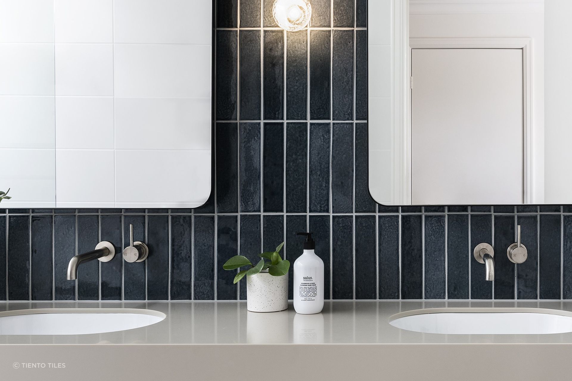 An elegant use of Motto Dark Blue Subway Tiles, vertically orientated for style