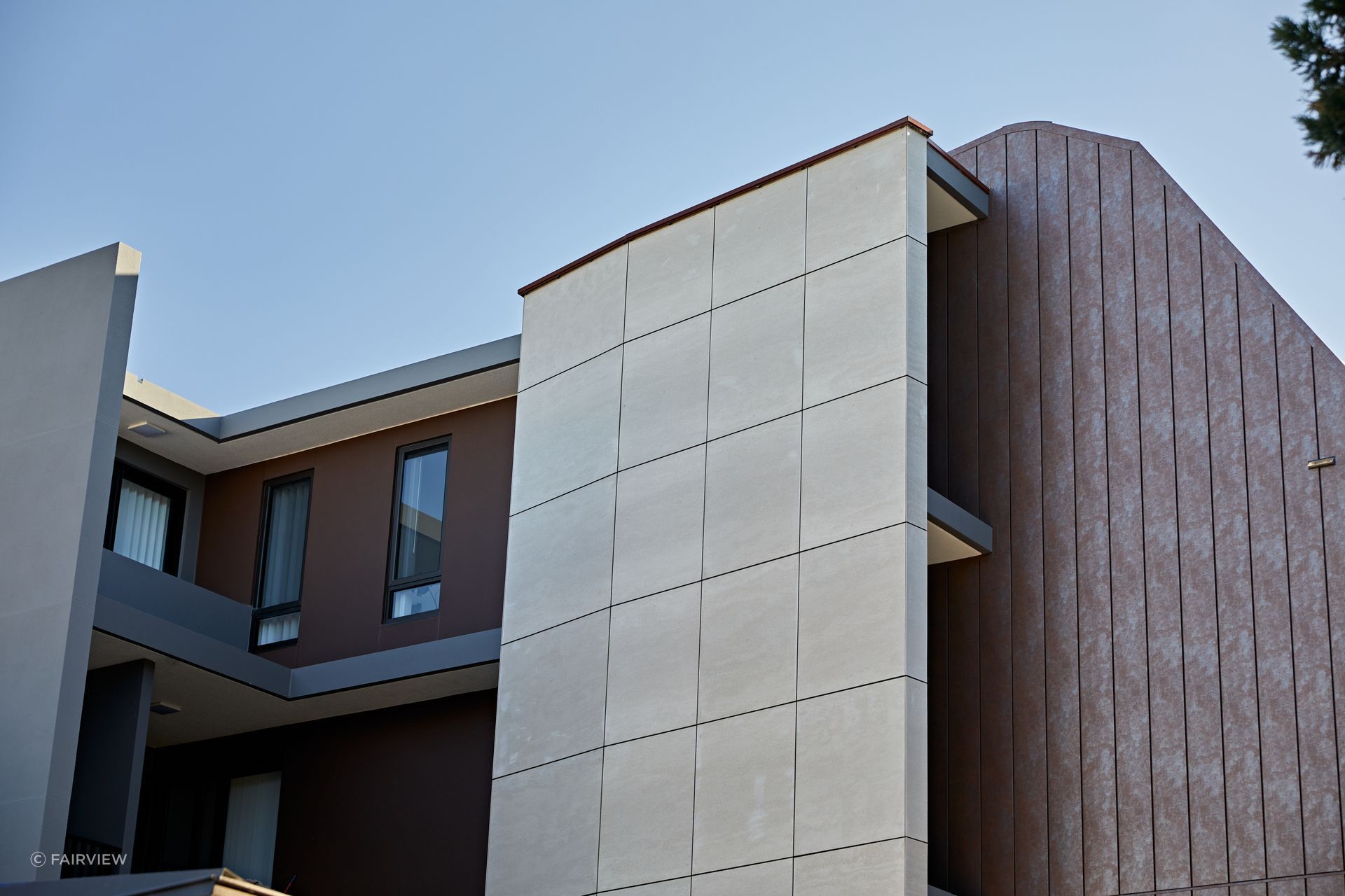 These fibre cement façade boards contrast well with the other materials used on the exterior of this building. Featured product: Genesis - Fibre Cement Cladding Boards.
