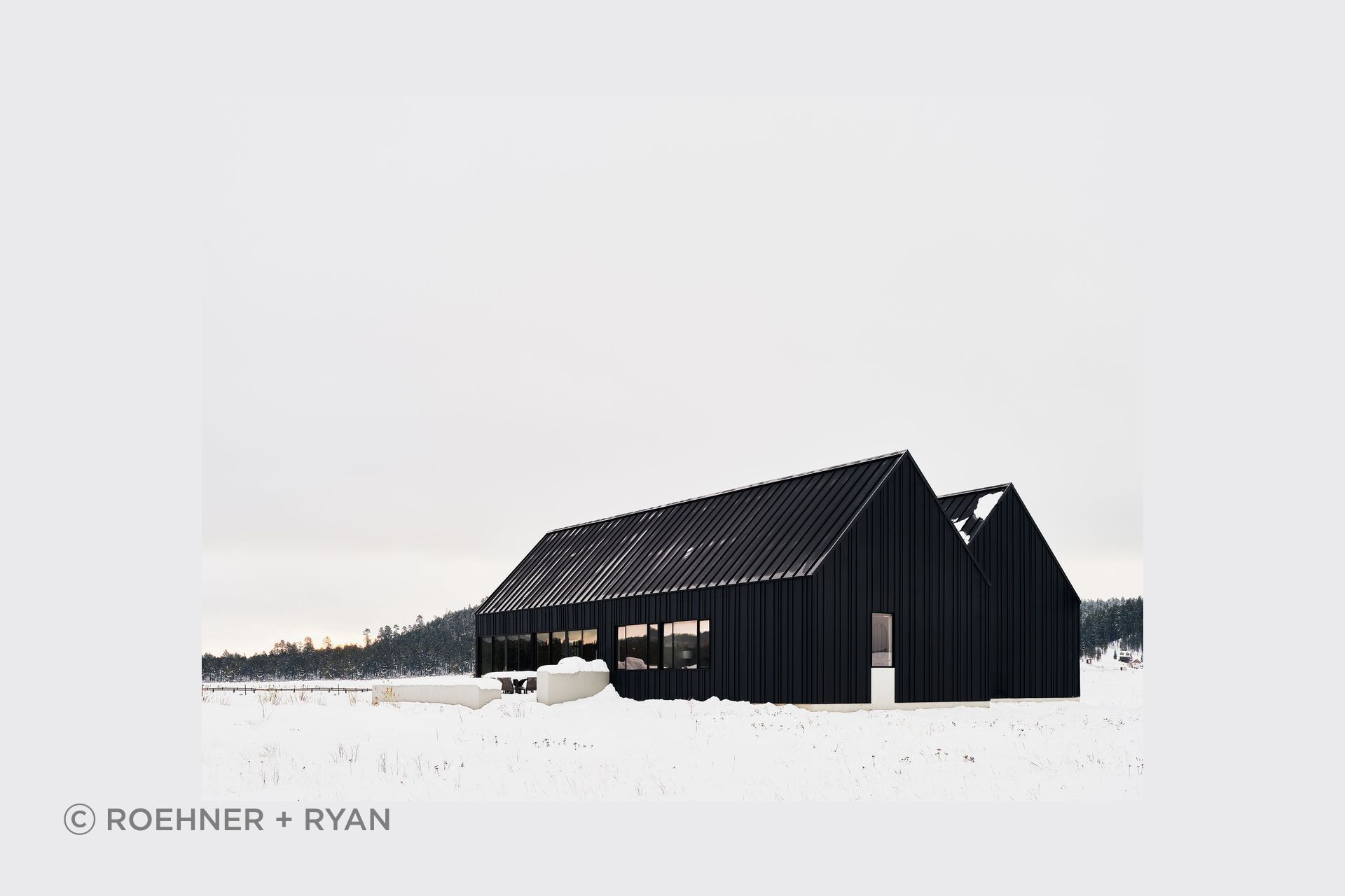 Noir Peaks by The Ranch Mine shows how a clear architectural form can shape both exterior presence and interior atmosphere, with a dark gabled silhouette giving way to warm timber, stone and light within.