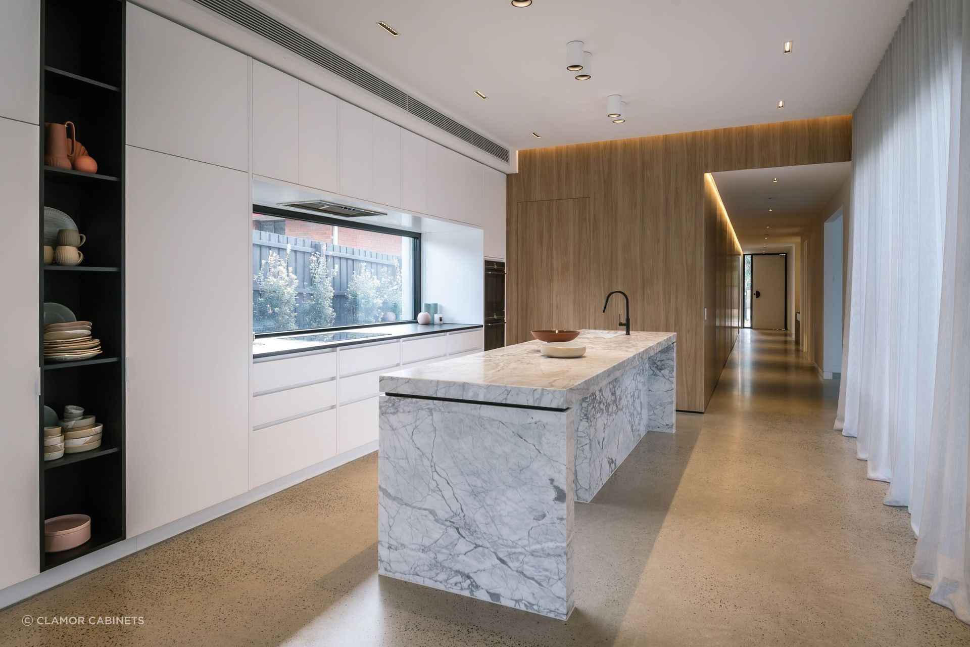 Sleek, integrated cabinets offer crisp lines and seamless aesthetics in this kitchen in Bonbeach. | Photography: Janis House Photography