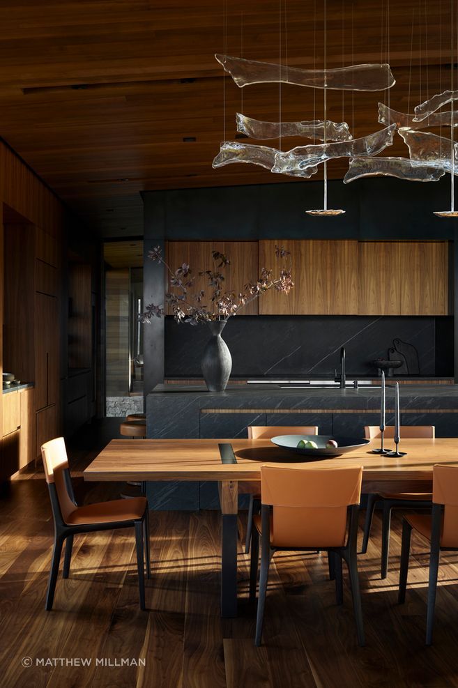 Walnut, stone and dark metal surfaces create a warm but highly resolved interior palette, showing how material specification can bring depth, permanence and craft to everyday spaces.
Architecture: CLB Architects