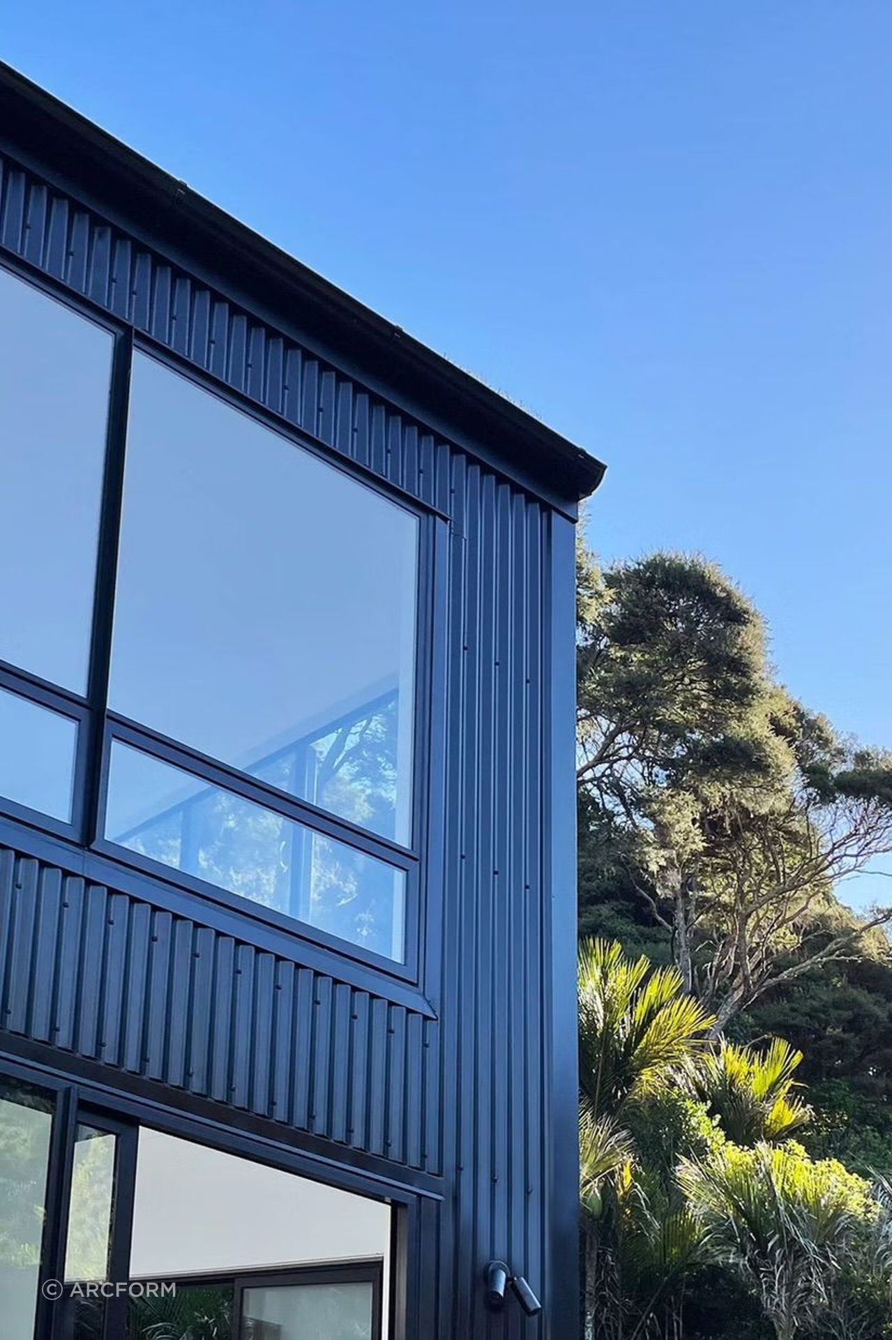 The black corrugated iron cladding pays homage to classic Kiwi building materials.