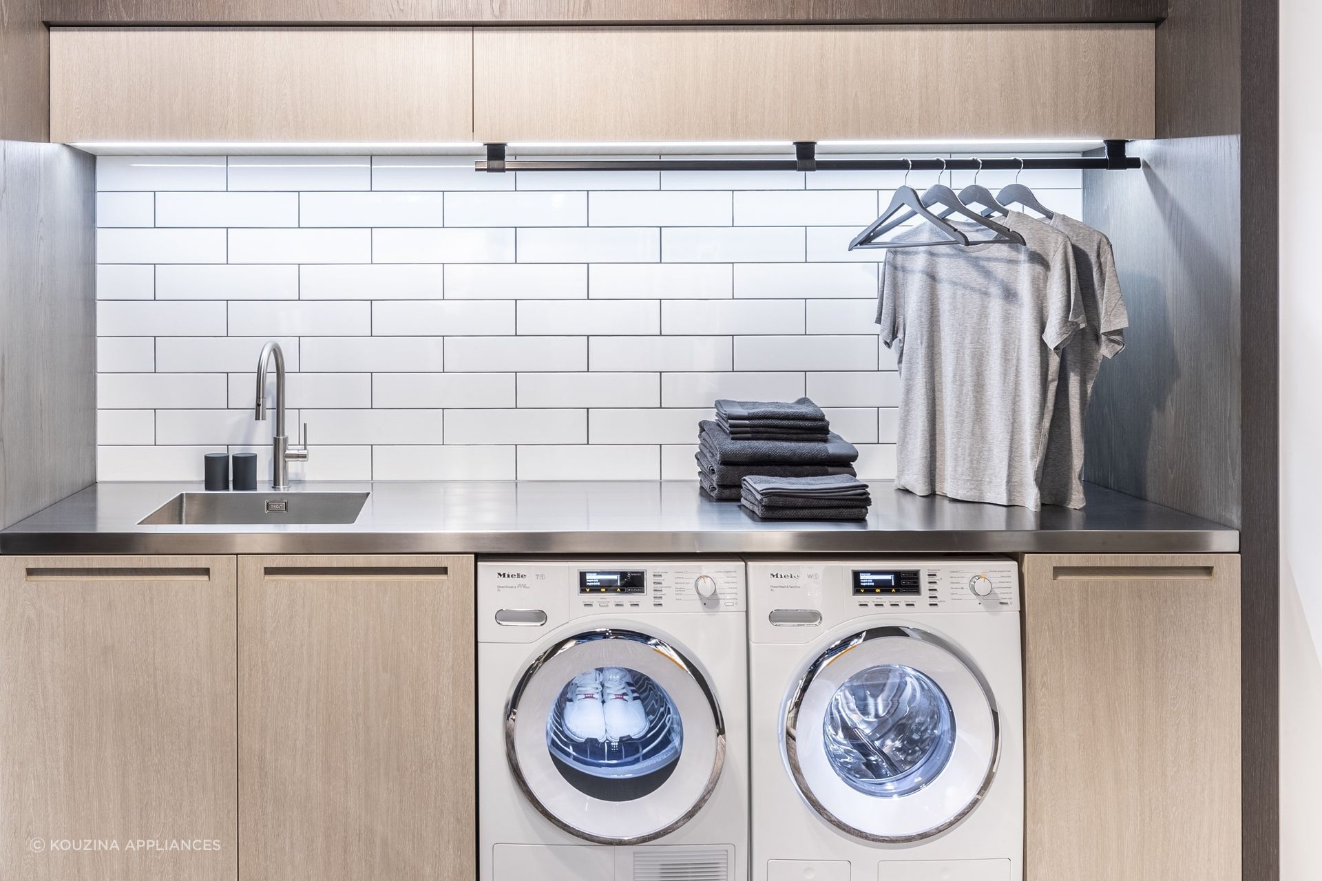 Classic subway tiles are a popular choice for a laundry splashback, seen here in a laundry featuring the equally popular 9KG Condenser Dryer with Heat Pump Technology by Miele.