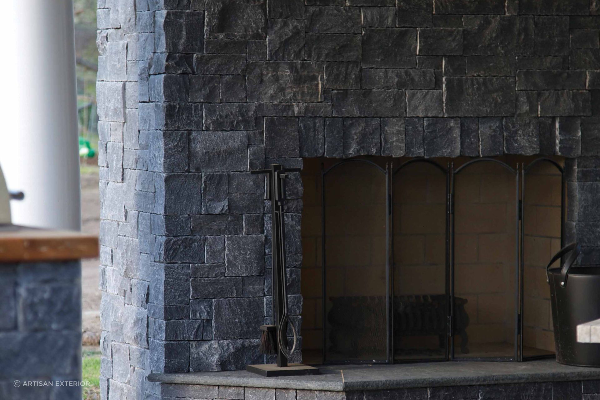 Noir modular stone wall cladding with its earthen charcoal appearance is a stunning cladding choice for a fireplace and the surrounding wall.