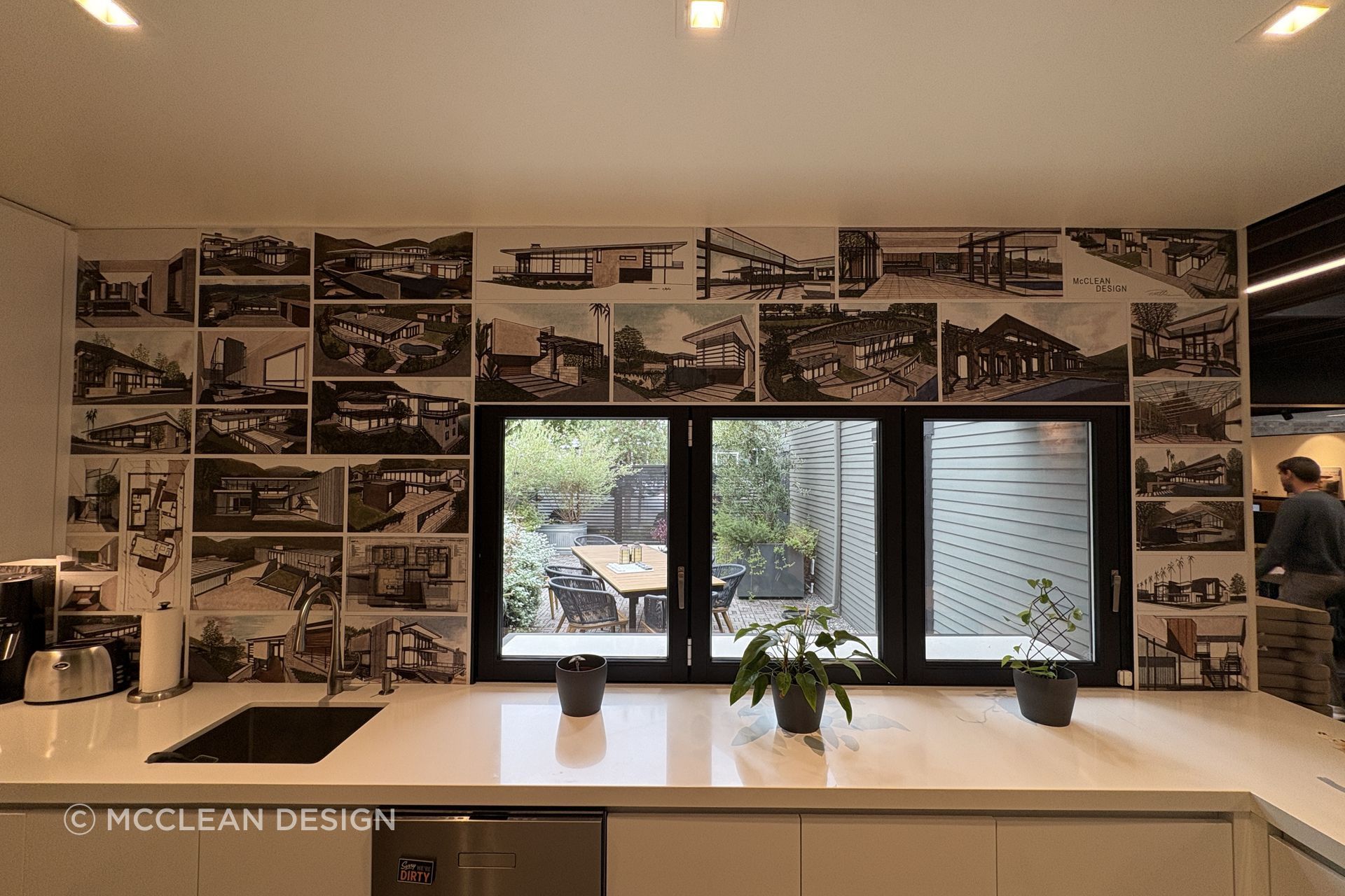 An archive of early McClean Design projects lines the studio wall, tracing the evolution of a practice defined by glass, light, landscape and livable modernism.
