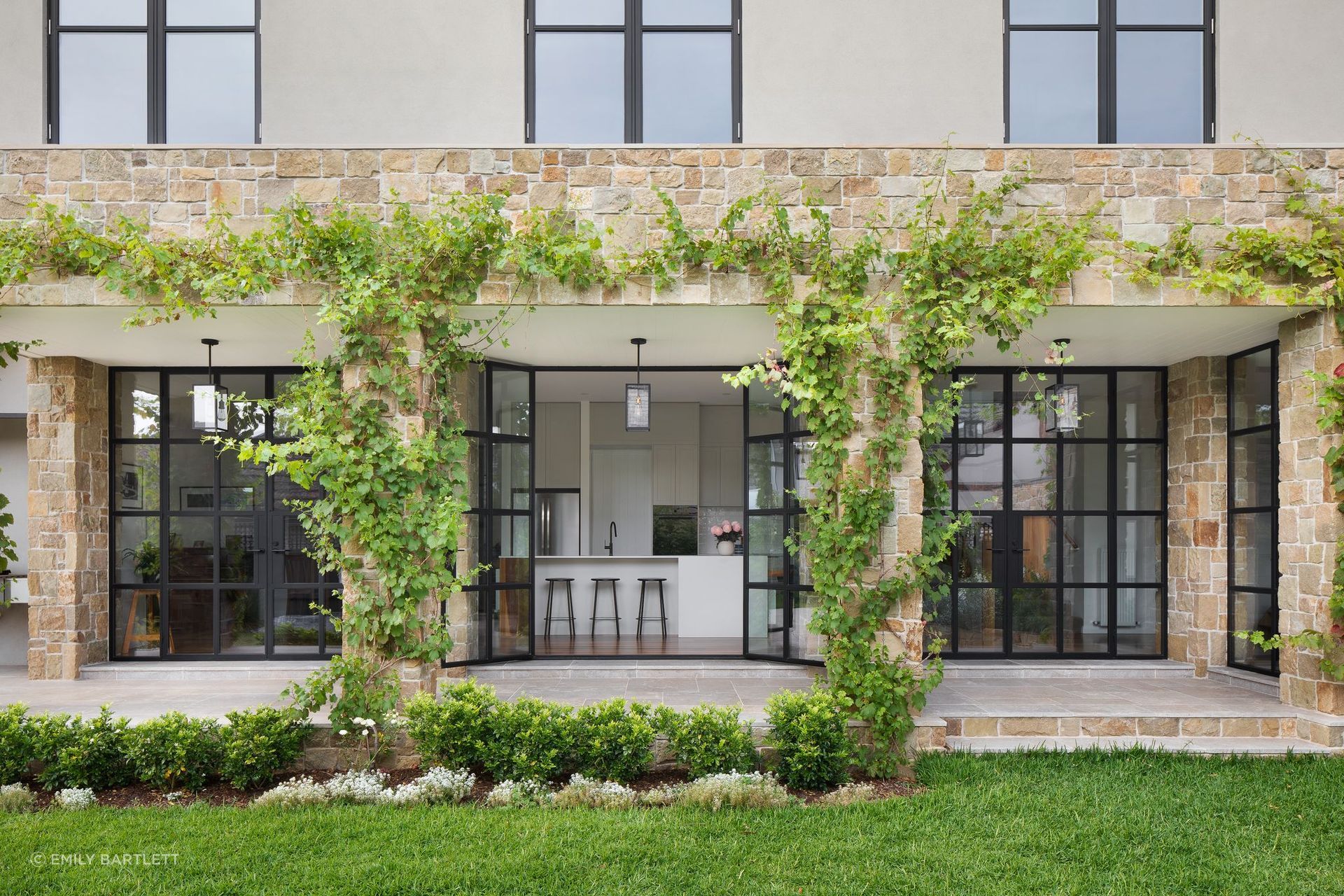 A timeless family home in Melbourne by Bryant Alsop blends traditional aesthetics with modern sustainability, featuring a spacious layout, natural materials, and a harmonious connection to the garden.