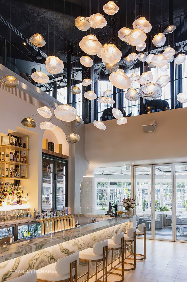 The largest Bocci commission in Australia to date, the cluster of 61 hand-blown Bocci 73 Series glass lights transform the Blowfish Ocean Grill + Bar on the Gold Coast designed by Space Cubed Design Studio. Photography by Harley McNamee courtesy of Bocci