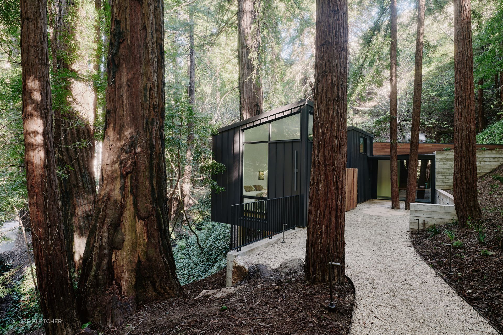 Big Sur Cabin: "The scale is what I'm most proud of," Schicketanz says. "When you drive past, you get a glimpse of something interesting at the end of the great room, and then the rest just blends into the hillside." That instinct, to let a building earn attention at one precise moment and disappear everywhere else, is what gives the Big Sur Cabin its particular character. It is a new structure that has already found its place.