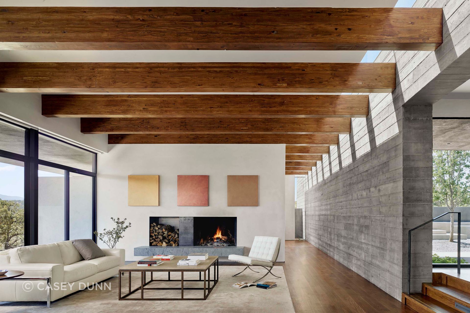 Inside Sangre de Cristo House, exposed timber beams, concrete masonry and measured daylight create a calm interior language that feels grounded in local construction and regional materiality.