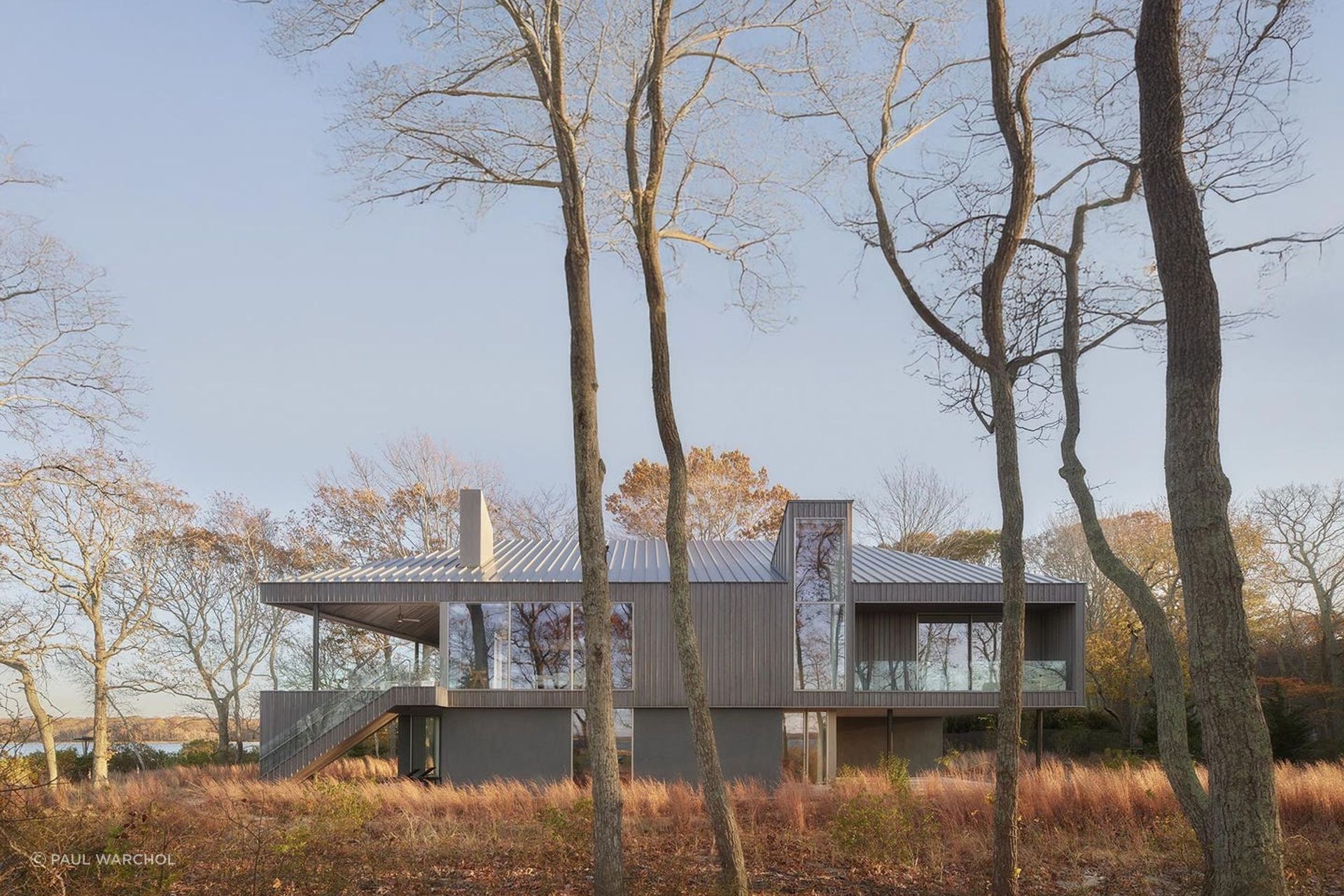 “Expansive glazing along the north facade provides stunning views of the nature preserve throughout the day,” Chia says. “A stair dropping down from the second level rests gracefully on the ground, connecting the social and private programs with each other and the site.”