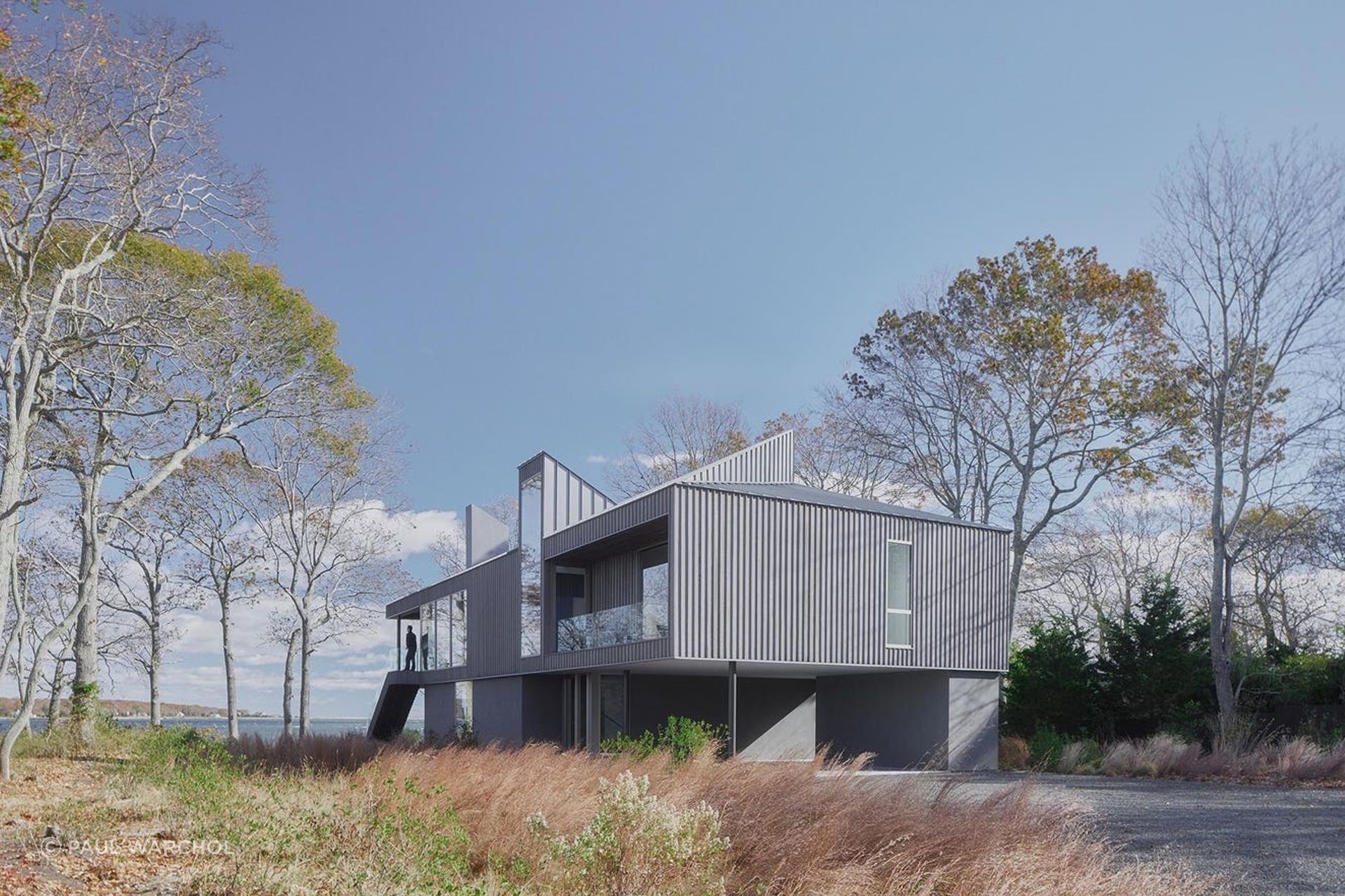 The house features a reverse floor plan, with gathering spaces and the primary bedroom on the second floor, and additional bedrooms on the first floor. “The home was inspired by native osprey birds whose ubiquitous nests appear atop trees, telephone poles and nautical piers,” says Chia.