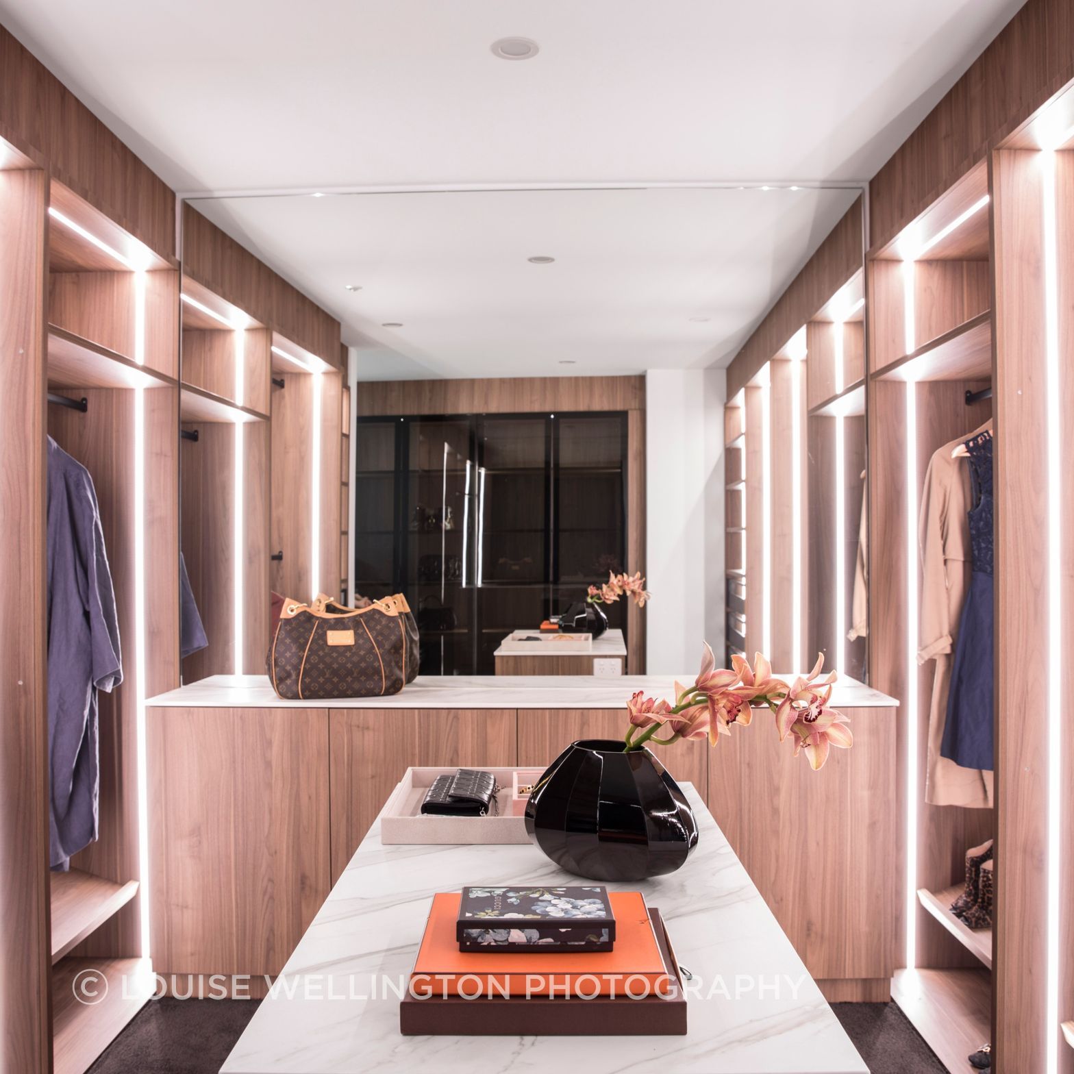 Oxford Project.  Walk in Robe and dressing room with warm timbers, functional lighting plan and Neolith clad dressing tables is the epitomy of luxury.