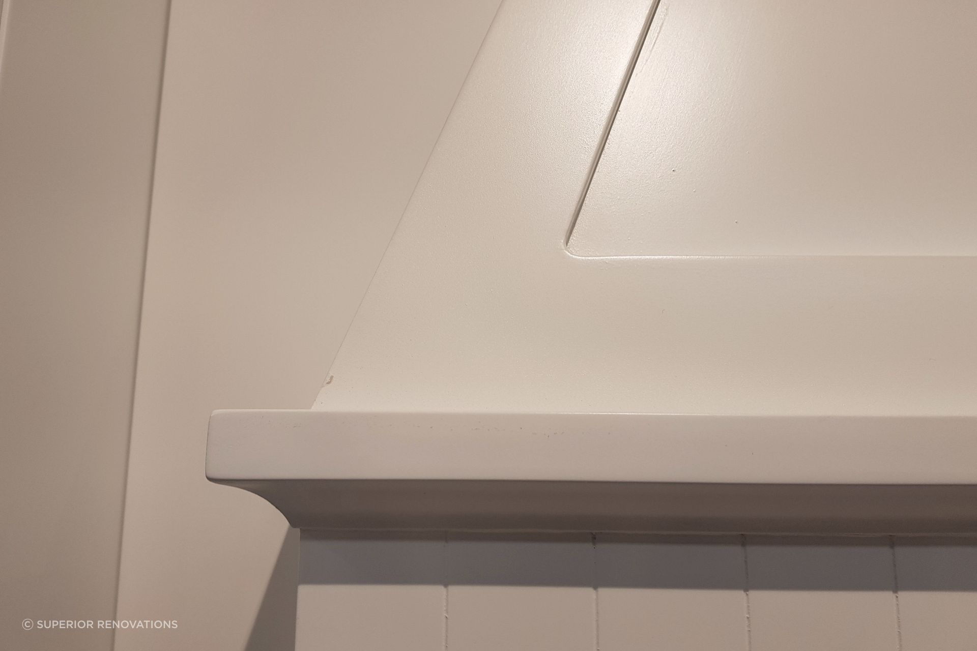 Handcrafted detailing in the hooded chimney in our kitchen showroom for our classic kitchen display