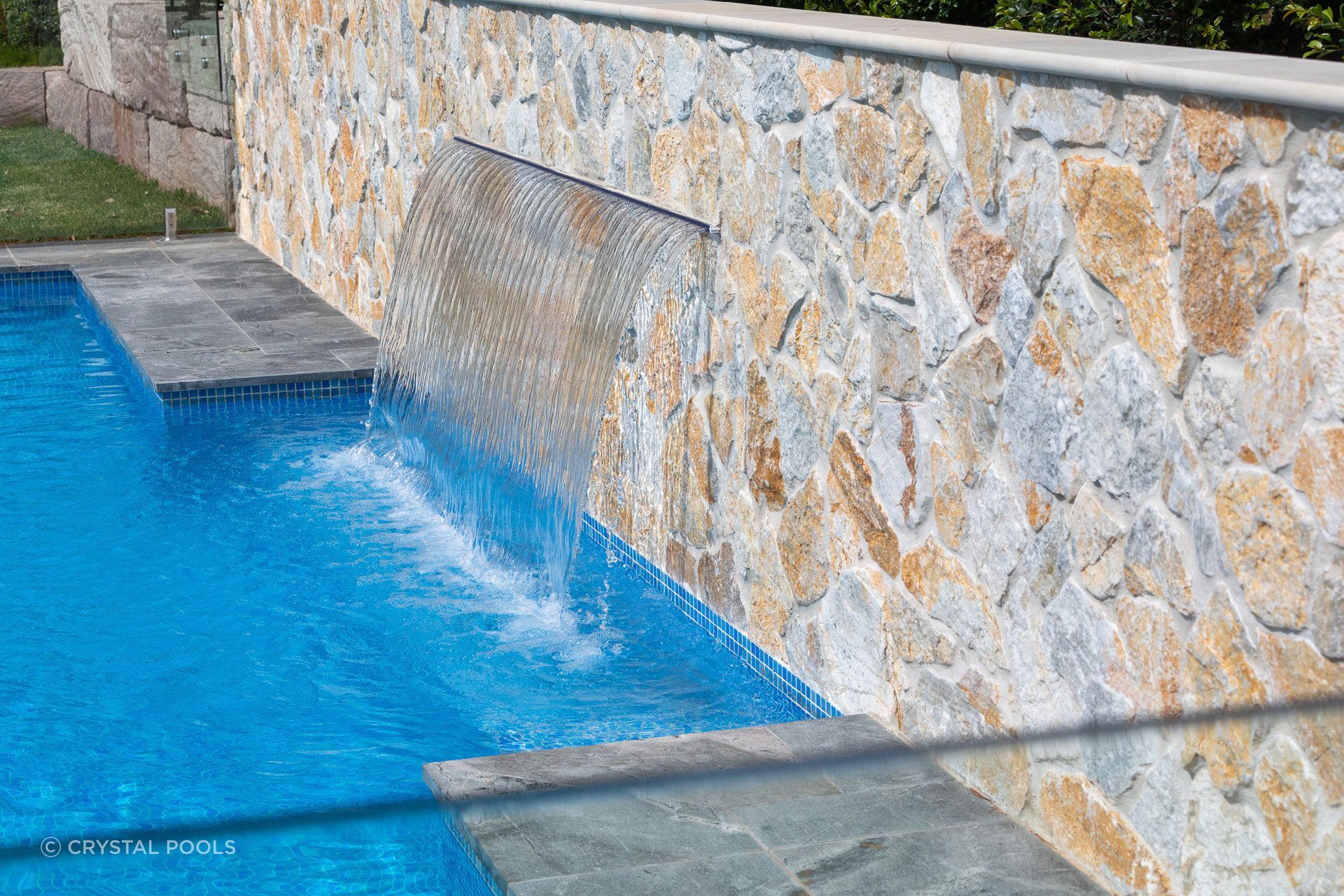 Summit wall cladding poolside. Natural stone that handles water, weather and everything in between.