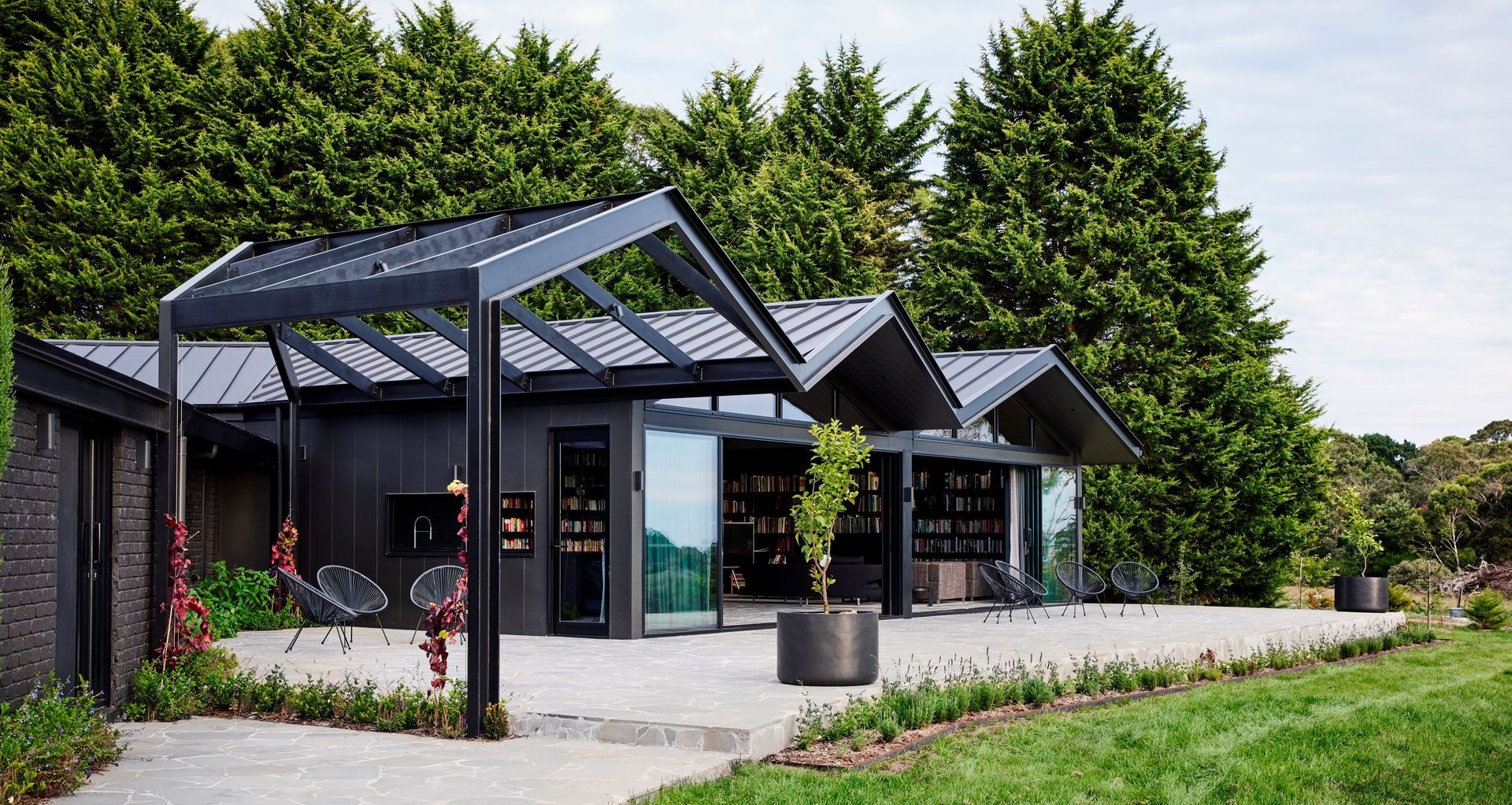 The brick exterior of this 1980s-era home and bold steel pergola have been seamlessly integrated thanks to a monochromatic refurbishment featuring Resene Lumbersider Low Sheen CoolColour in Bokara Grey on the bricks and Lumbersider Low Sheen CoolColour Black on the pergola. 

Project: Atlas Architects. Image: Tess Kelly.