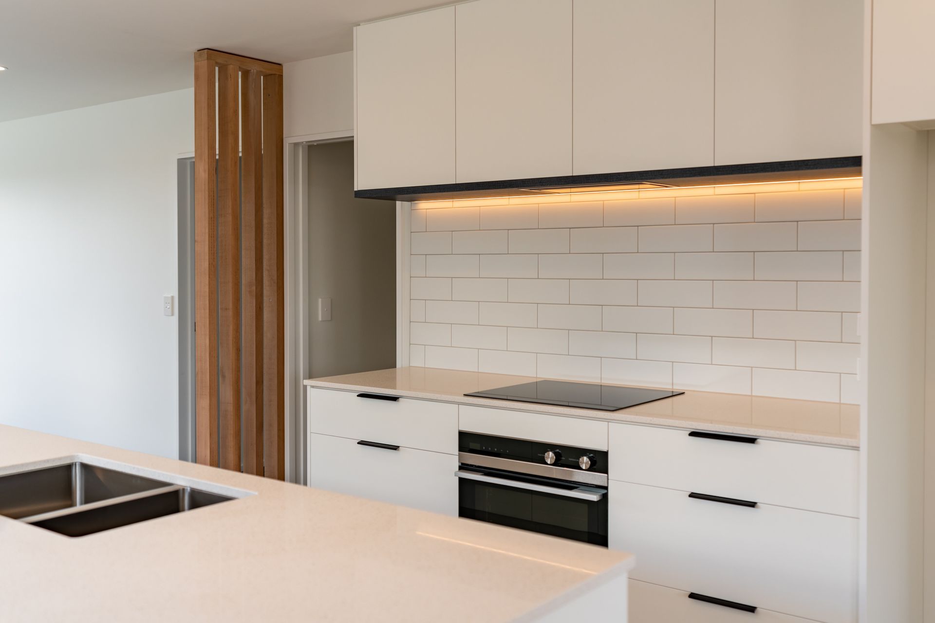This contemporary kitchen features Fisher &amp; Paykel appliances and a subway tile splashback, designed by Modern Age Kitchens &amp; Joinery.