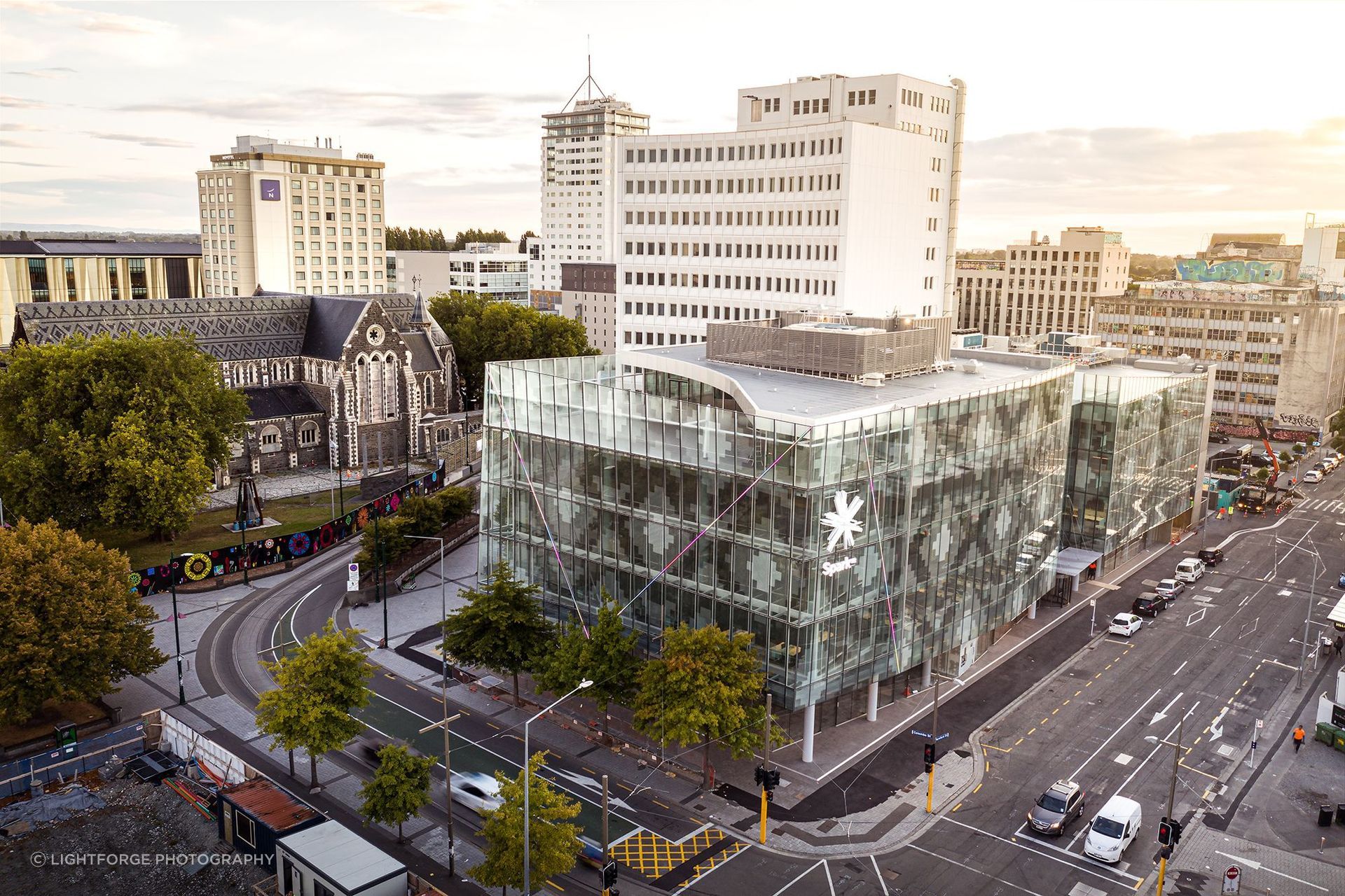 A contextual view of 2 Cathedral Square, showing the patterned glazed facade in relation to the patterned slate roof of ChristChurch Cathedral. Photograph: Dennis Radermacher/Lightforge.