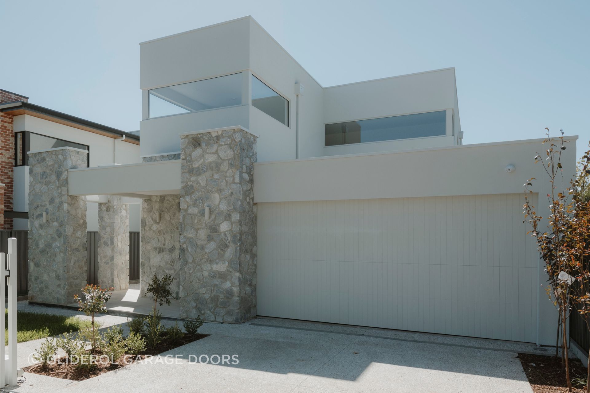 Real Timber Garage Door in Danmar Vertipanel design painted white