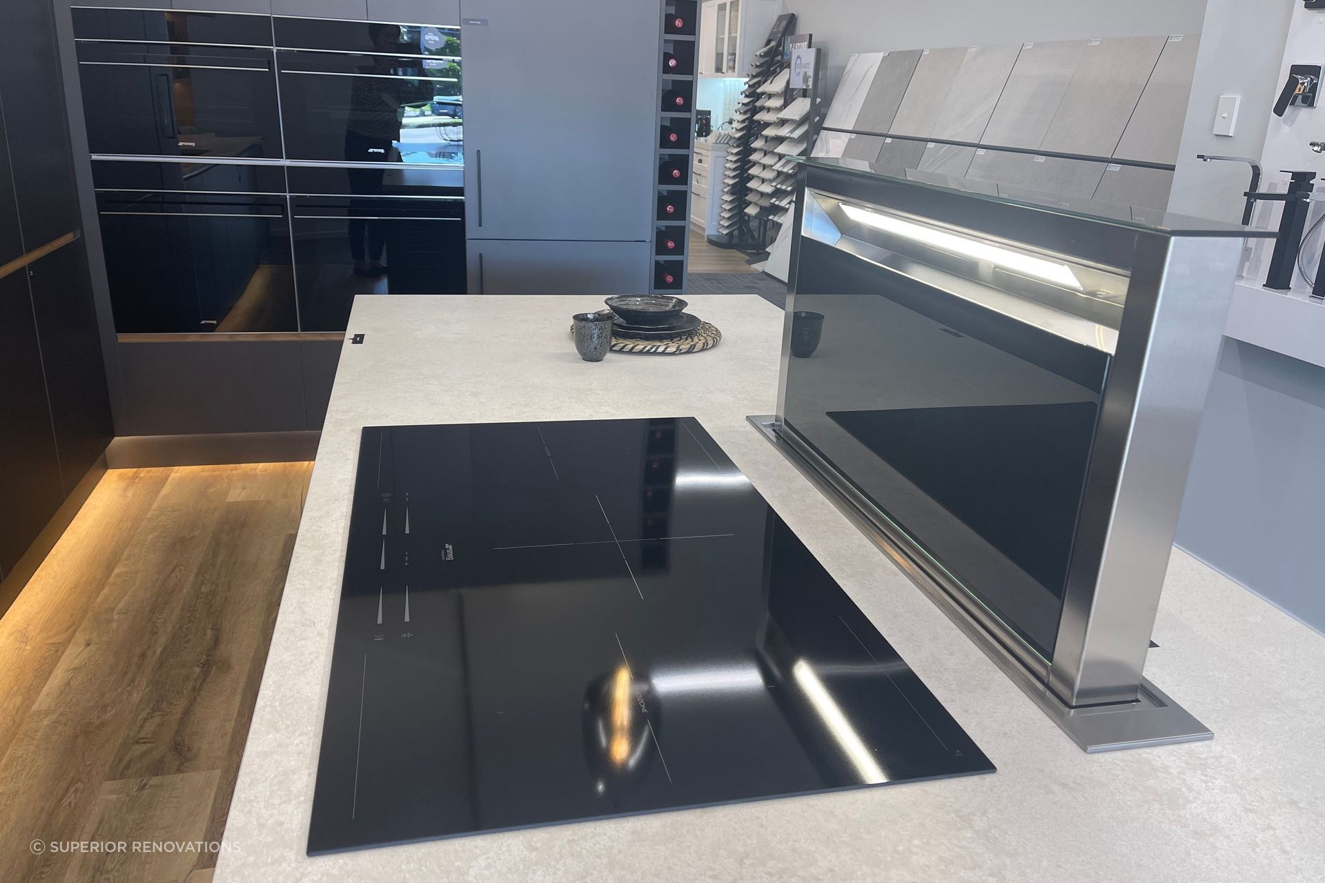 When in use the downdraft range hood comes up from the benchtop. This can be seen in our kitchen showroom in Auckland (Wairau Valley).