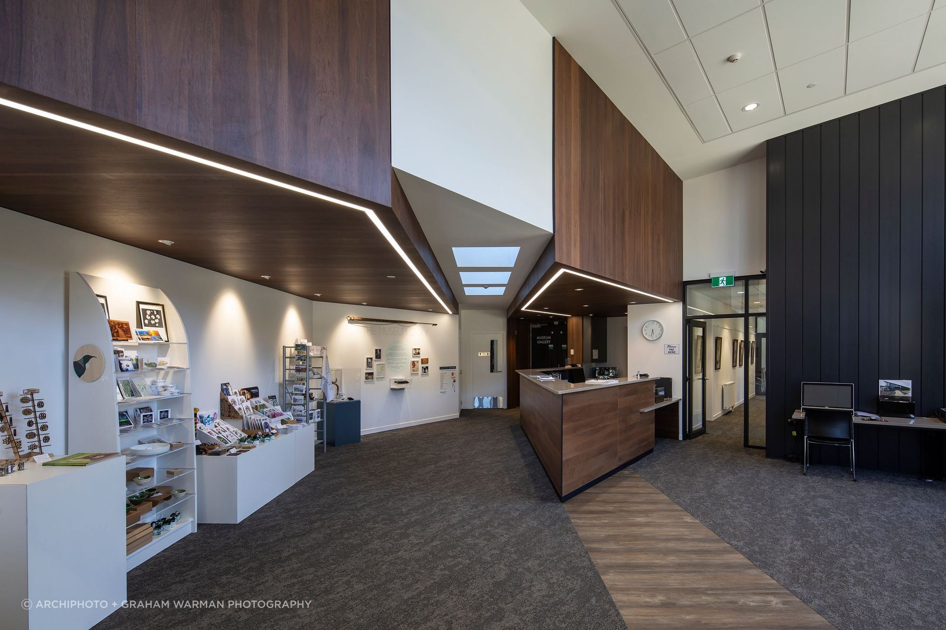The entry foyer is filled with light; the corridor to the right of the reception desk leads to the offices and cafeteria, while to the left are the museum galleries.