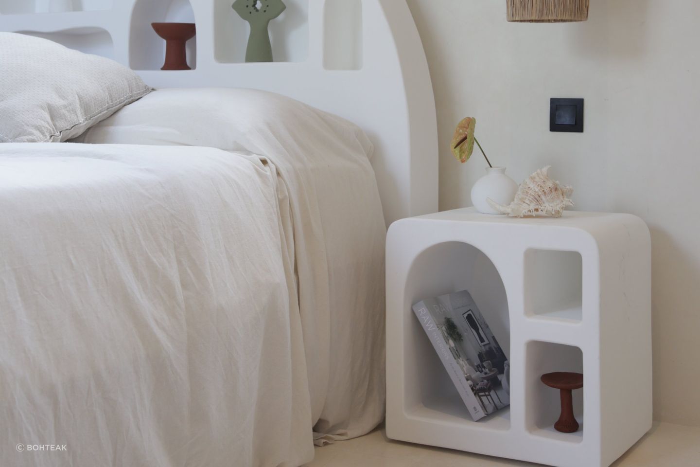 A minimalist bedroom with a clean interior design is a great setting for a Mediterranean bedside table. Featured product: Mykonos Side Table.
