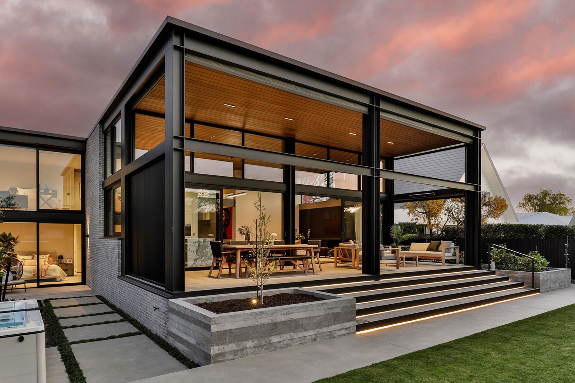 The fully glazed northern side of Modern Residence, a striking contrast to the brick-clad front elevation. | Photographer: Jamie Cobel