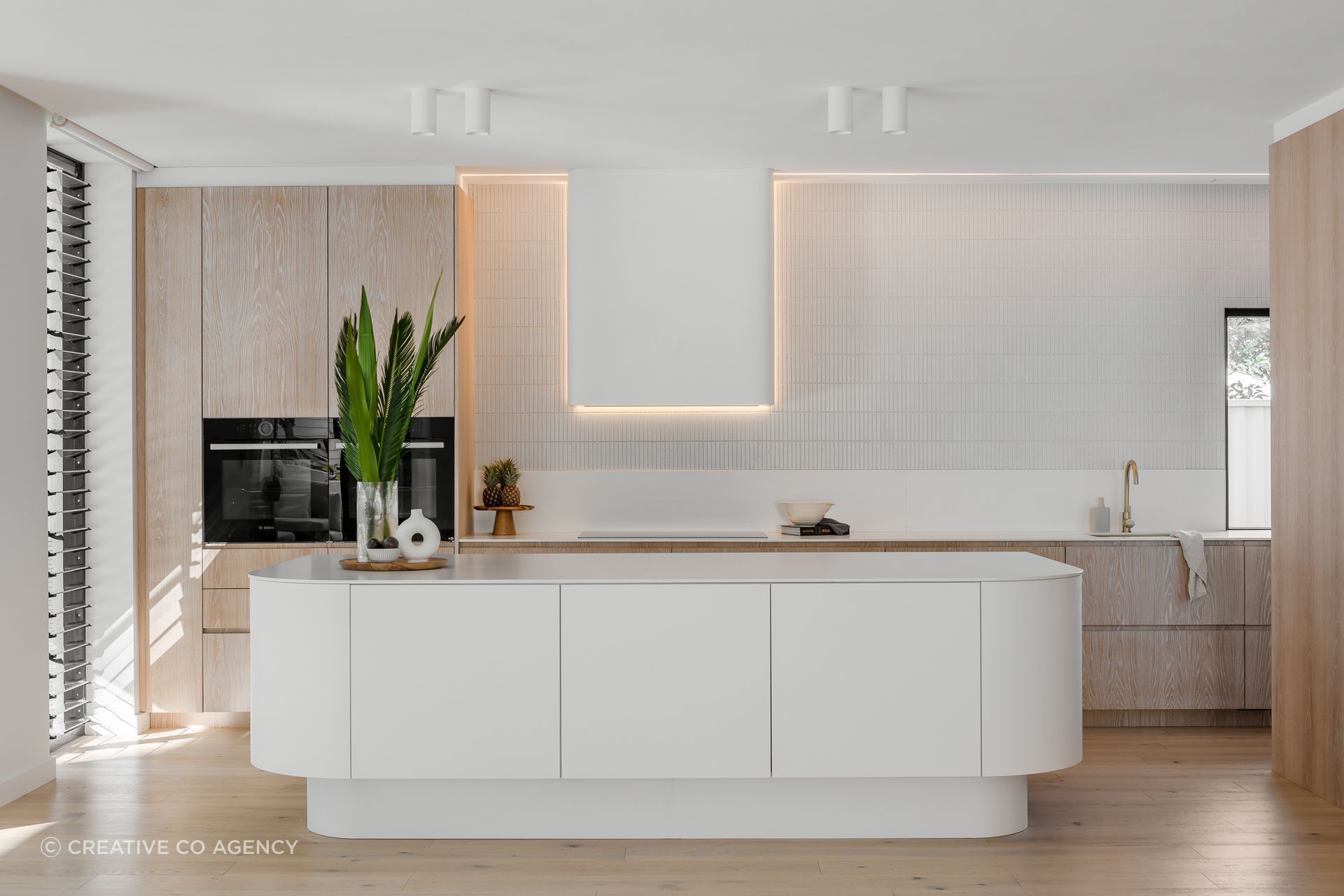 Springshome. Palm Springs inspired interior design. A Coastal, layered neutral colour palette, with Neolith Sintered Stone benchtops and Farmers Doors limewash cabinetry create a calming space for family entertaining. 
A Signature Services Kitchen and Joinery design.