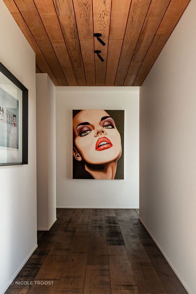 The hallway to the guest wing doubles as a gallery for the owners' art collection. The hallway to the guest wing doubles as a gallery for the owners' art collection.