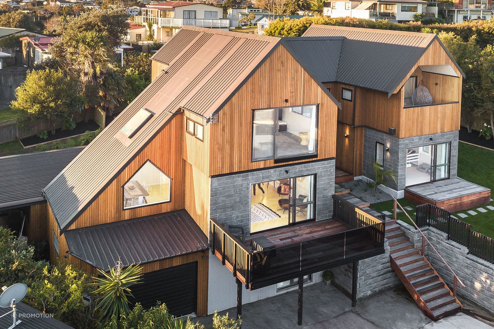 The home is clad with cedar shiplap by Hermpac and the roofing is Trimrib in Ironsand by Roofing Industries. Homeowner and builder Tony Buchanan installed the roof himself with his crew - some of the runs were up to 12m long.