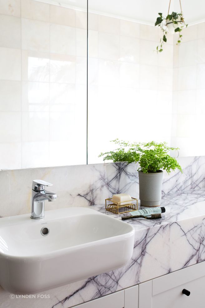 The master ensuite is modern yet tactile with a stone counter top.