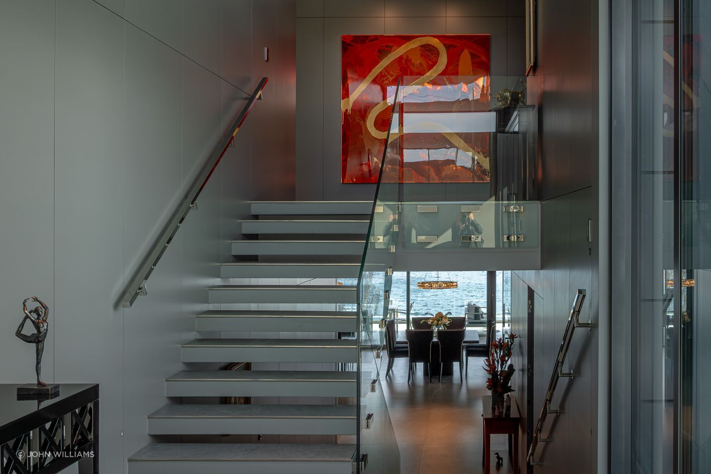 In the foyer, staircases seem to float, and bannisters glow, backlit by LED lights.
