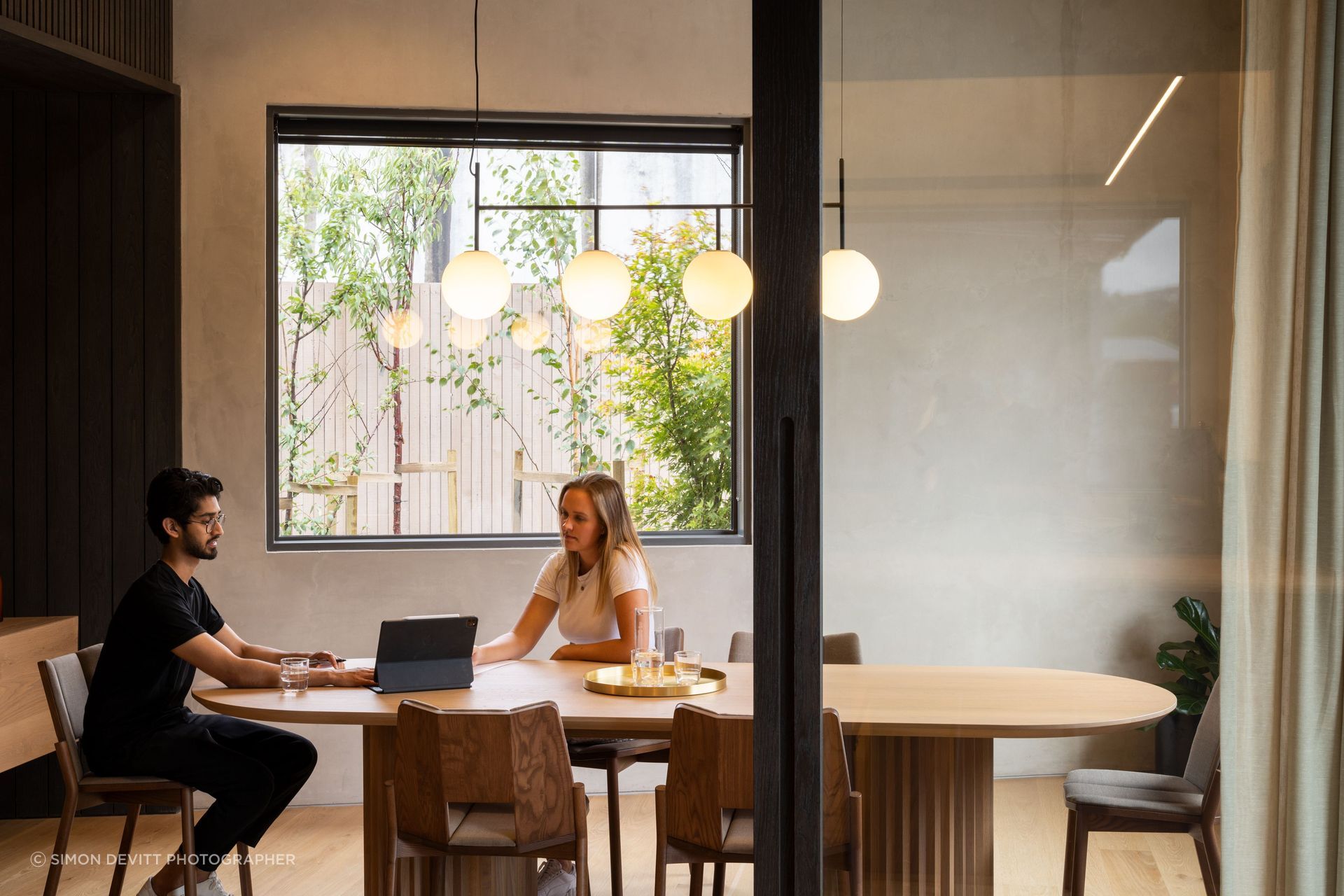 The interior wall is an exposed tilt panel concrete panel that has been rendered. The Menu suspension light is from Simon James.