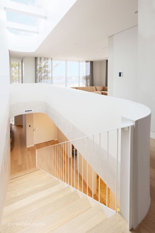 The curve wraps around upstairs to a second lounge area.