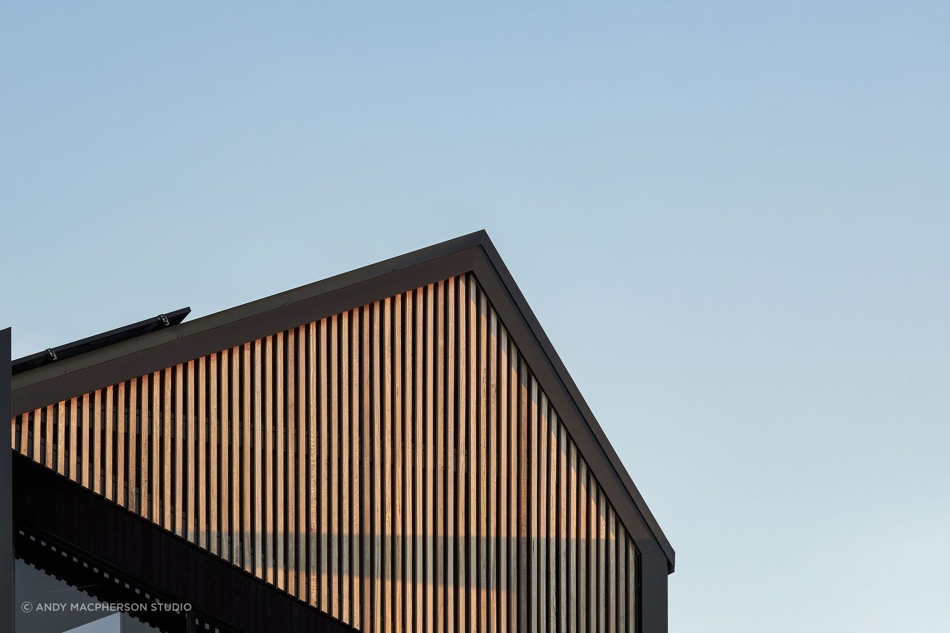 The facade, a canvas of rich hues and textures, tells a story that evolves with the sun's journey.