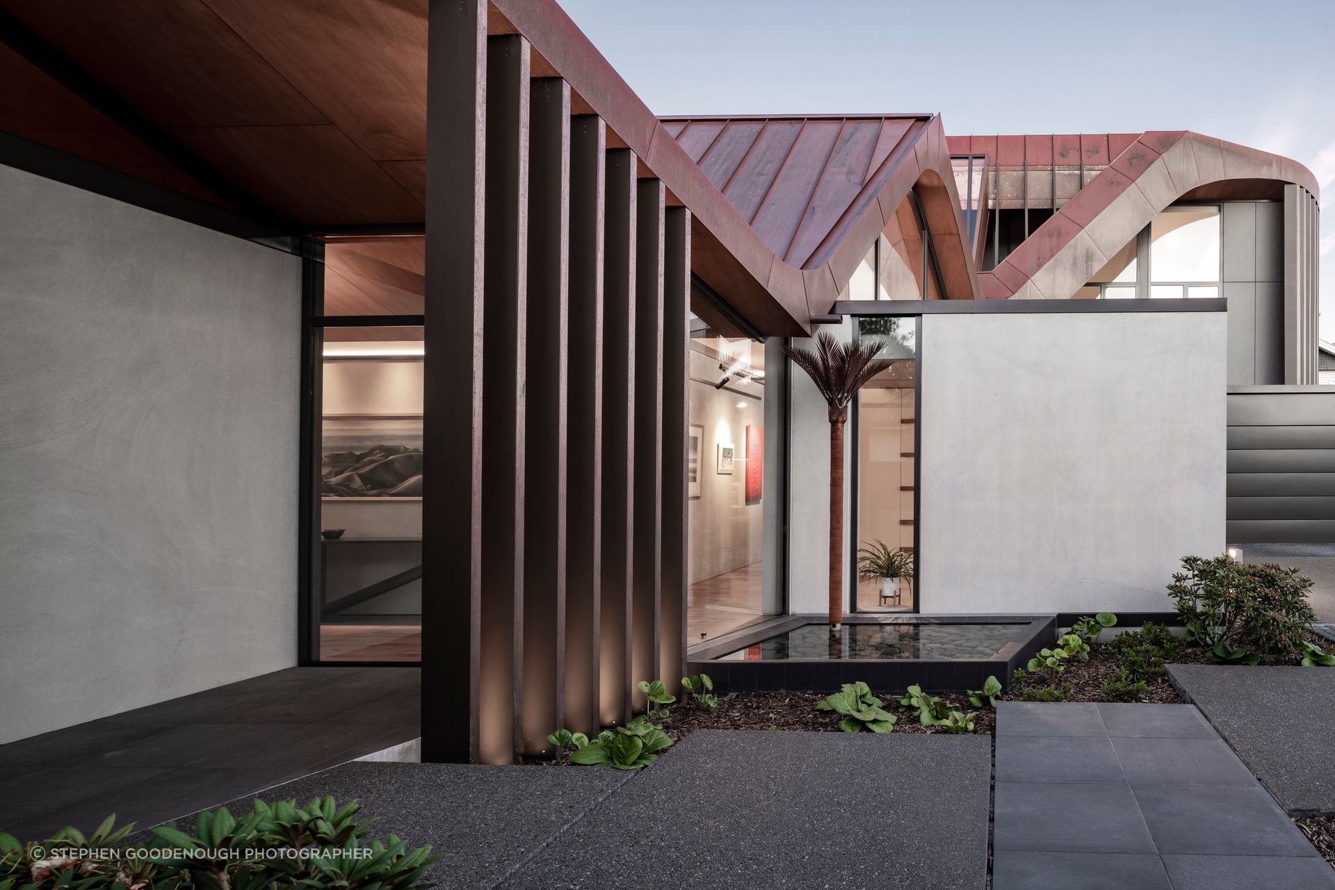 Very clever downpipes in the form of nīkau sculptures by Jane Downes preserve the shape of the roof.