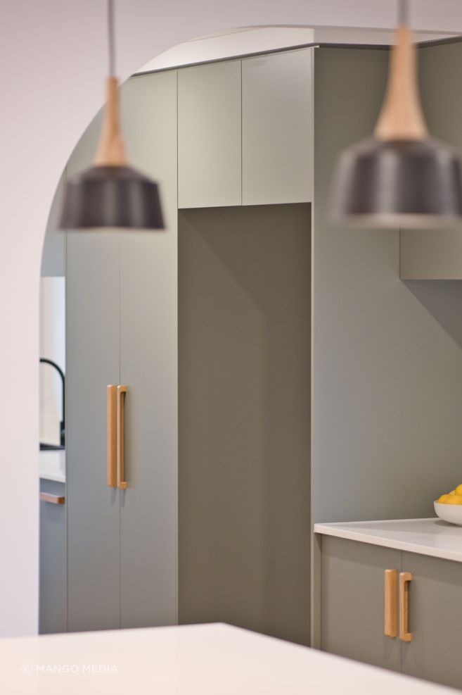 "Everyone wants that coastal feel, and they’ve done this in a modern way with flat kitchen cupboard panels and sage green which makes a big impact."