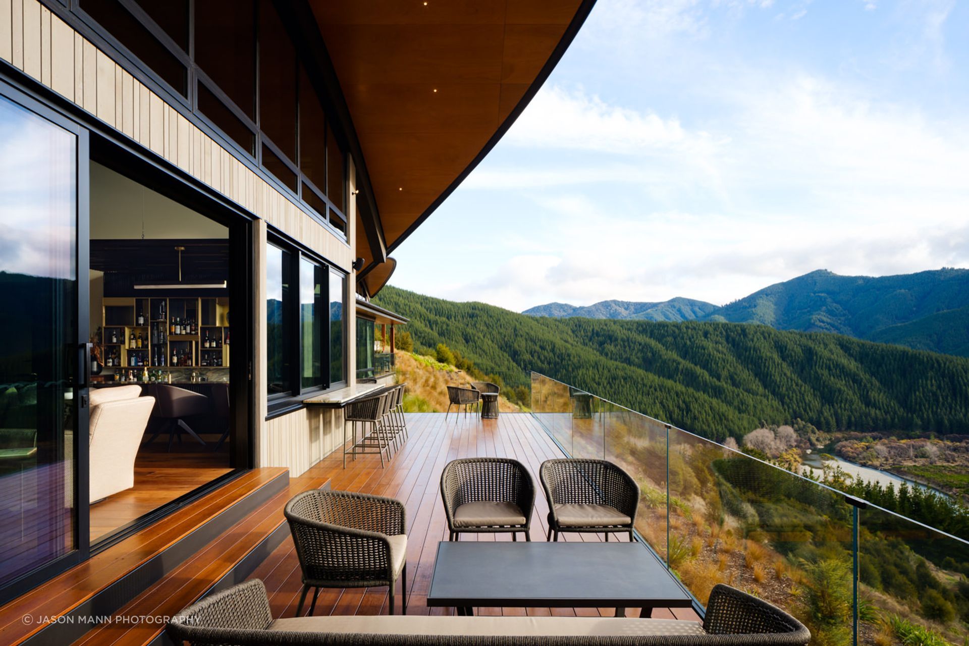 A deck off the bar area. The roofs give glimpses of mountains and rocky outcrops. “That gives you an idea of the building being more planted, and that you can actually see the native bush around you.”