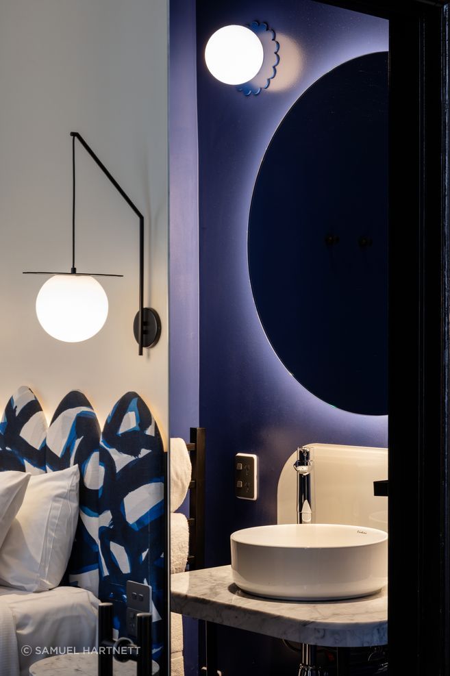 The bedhead fabric in the guest room is by James Dunlop. Every bathroom is in one of four different colourways.