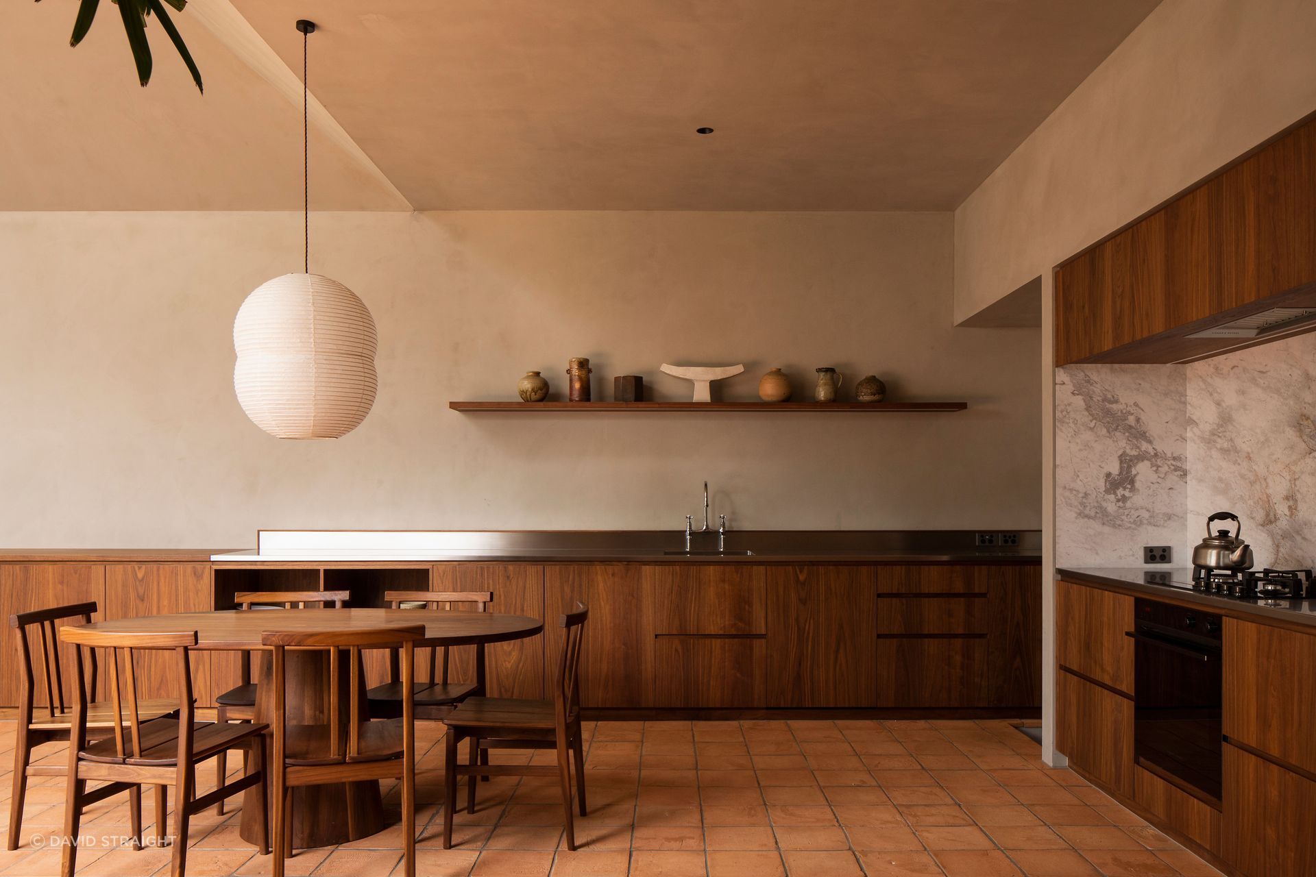 The kitchen area wraps around a corner of the extension. The walls are finished with Resene Rockcote Otsumigaki, a system in the tradition of lime and clay based Japanese plasters.