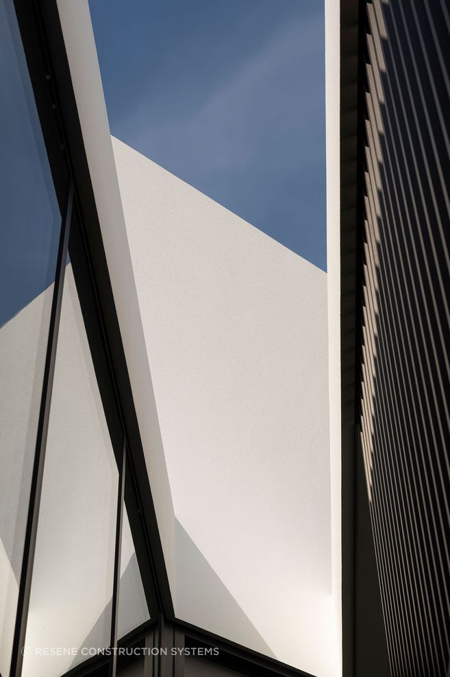 The  shadows from the cedar fins are beautifully reflected by the glass and as shadows on the plaster surfaces, creating a constant play of light and shadow.