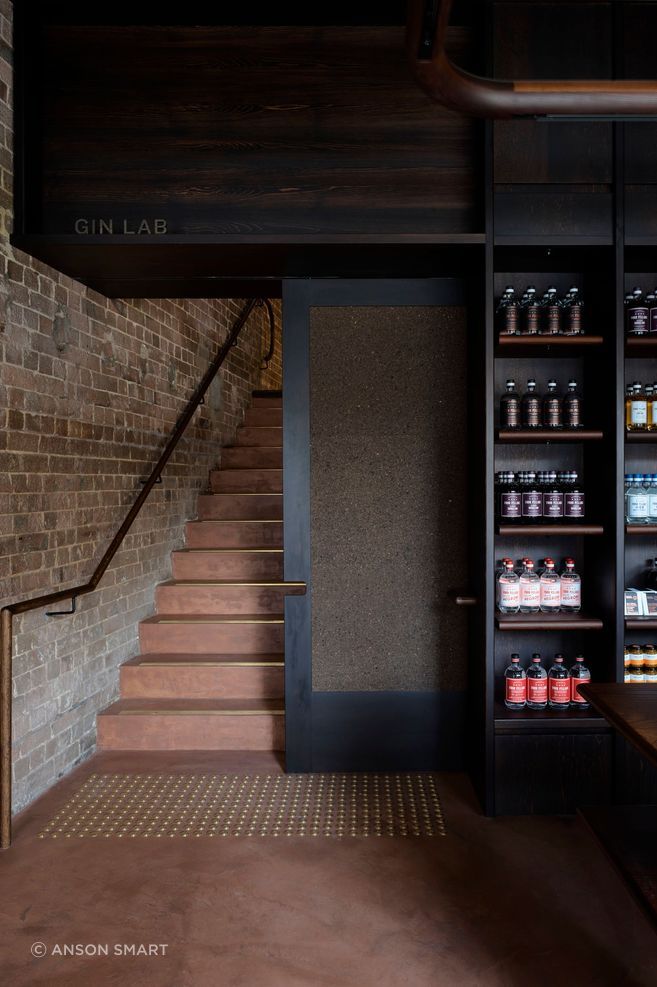Micro-cement rendered walls and floors with a Pandomo finish add a rustic vibe with a nod to the Four Pillars’ copper-toned logo.