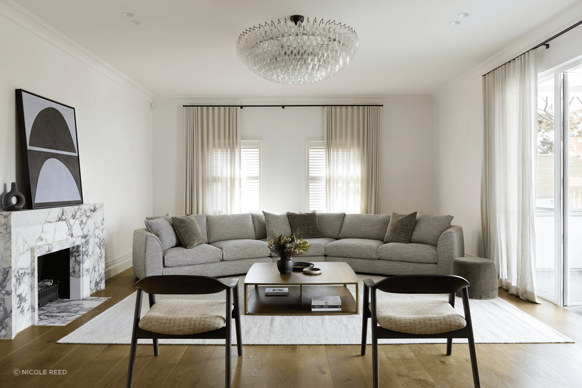 The Erskine sofa featuring a 30 Degrees Module, a fresh addition to the existing Erskine modular sofa. Placed at the centre of the sofa layout, this new module forms an impressive, curved sofa, perfect for larger spaces. This sofa is complemented by the new Karm Lounge Chairs, also presented in the smoked oak stain.