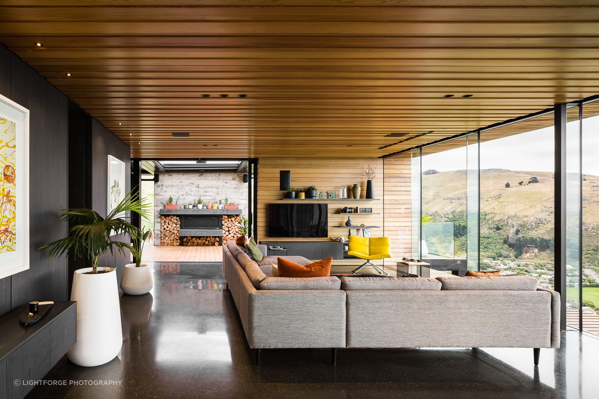 The open-plan living space leads directly to the outdoor living space through floor-to-ceiling sliders.