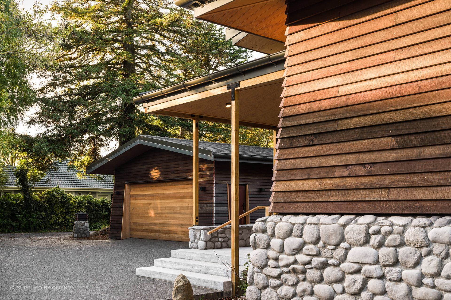 A long driveway marks the transition from the public to the private spaces. Its end reveals a California native, a grand, old redwood tree.