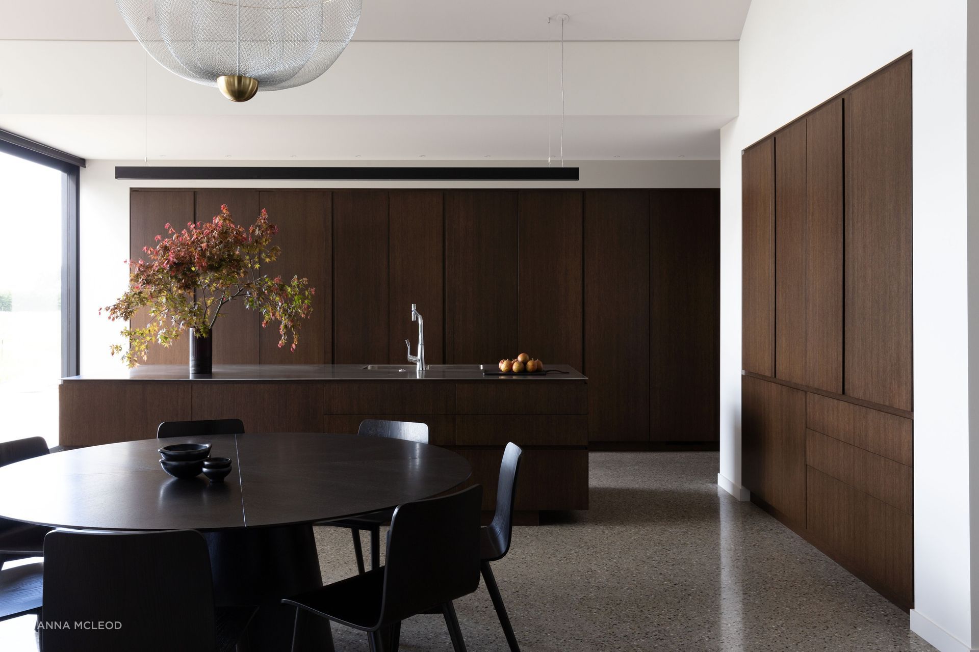 The kitchen, open spatially yet hidden away by large oak sliding doors | Photographer: Anna McLeod